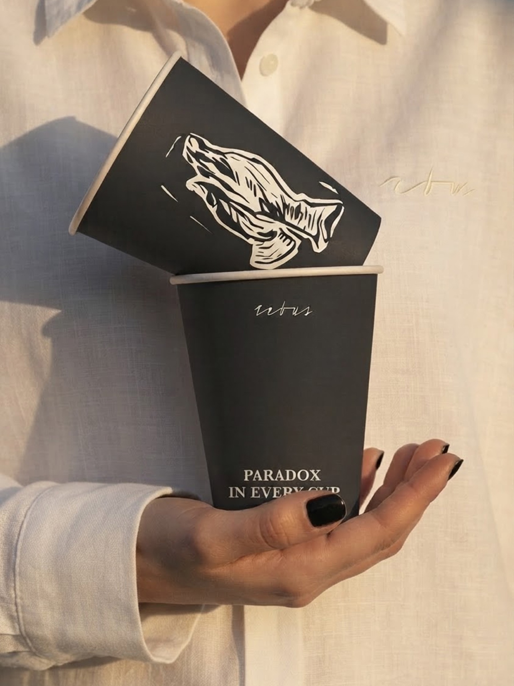 Rebus coffee cup branding, close-up photograph